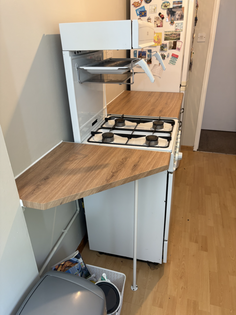 Wood effect wrapped worktop beside the hob in Bowthorpe