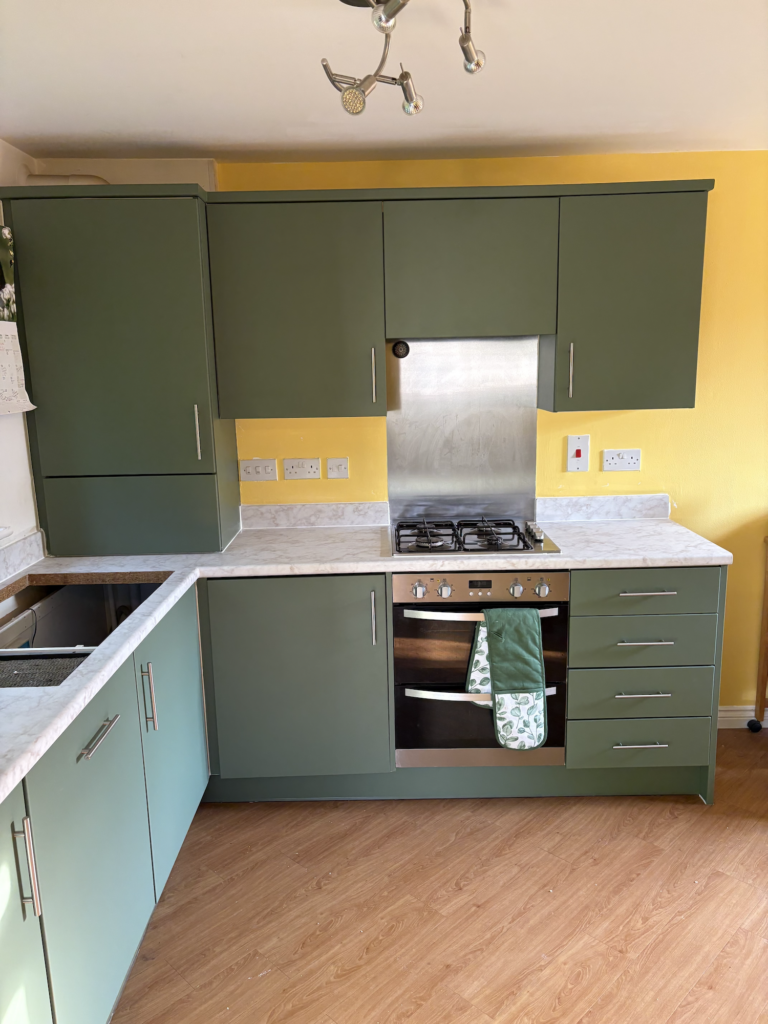 Green vinyl wrapped kitchen cabinets in Dereham