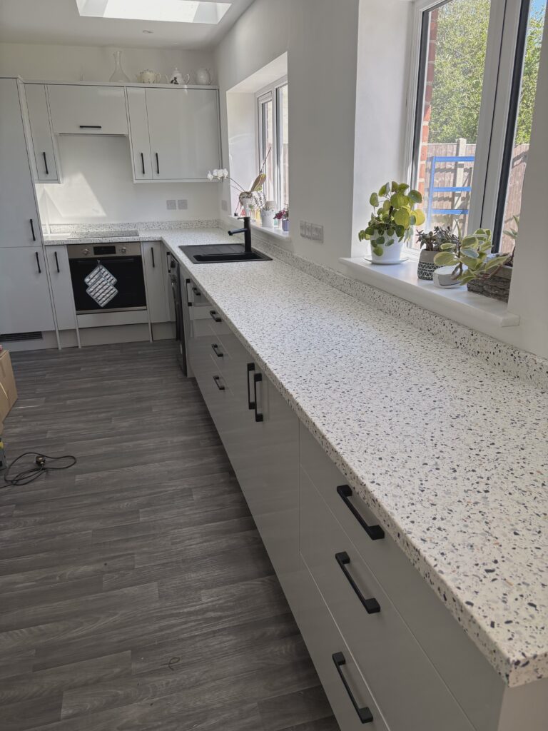 Grey kitchen cabinets and speckled worktop