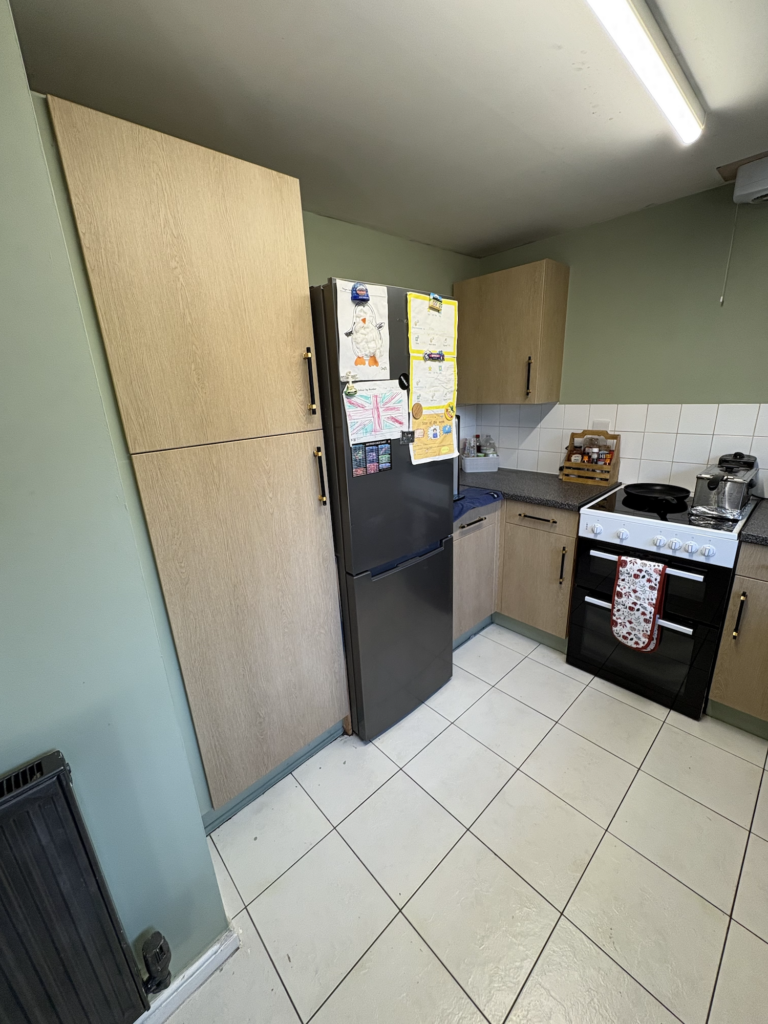 Light wood wrapped tall kitchen cabinets in King's Lynn