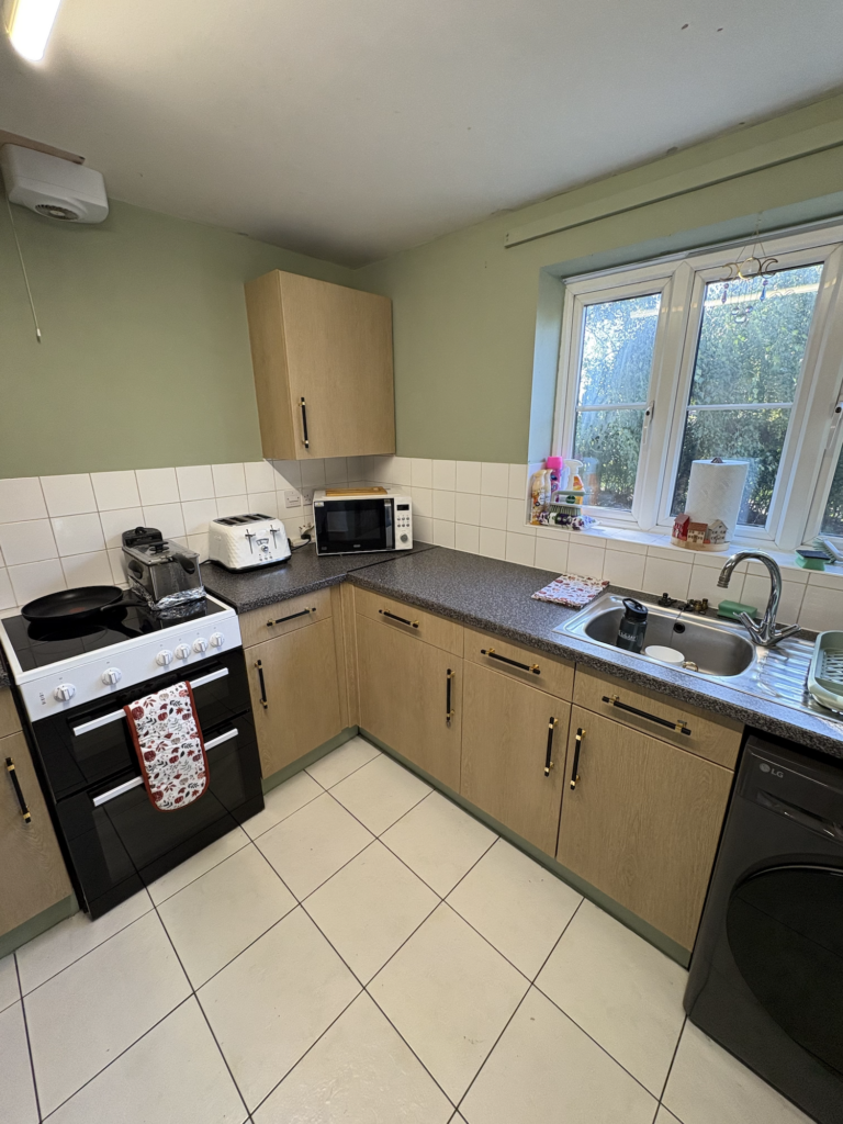 Light wood vinyl wrapped kitchen cupboards in King's Lynn