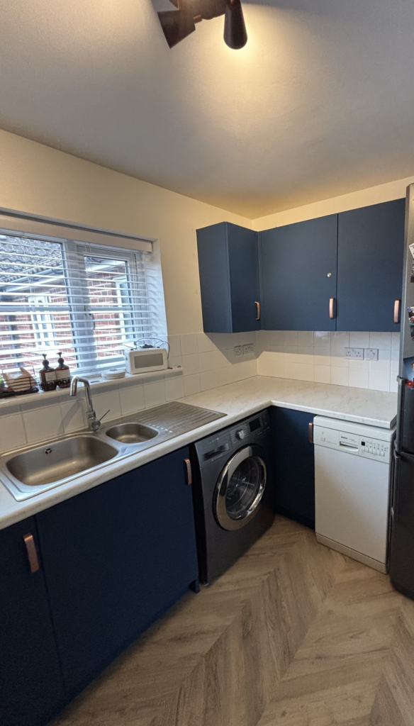 Blue wrapped kitchen cupboards and sink area in Newmarket