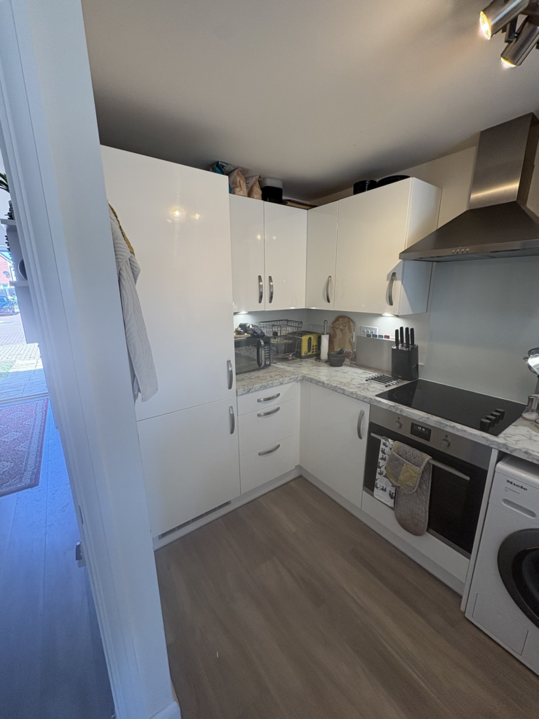 White kitchen cabinets and grey worktop in Rackheath