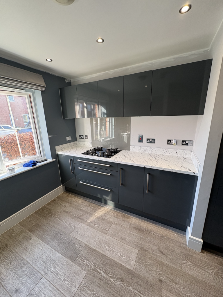 Grey vinyl wrapped kitchen cabinets and white worktops in Swaffham