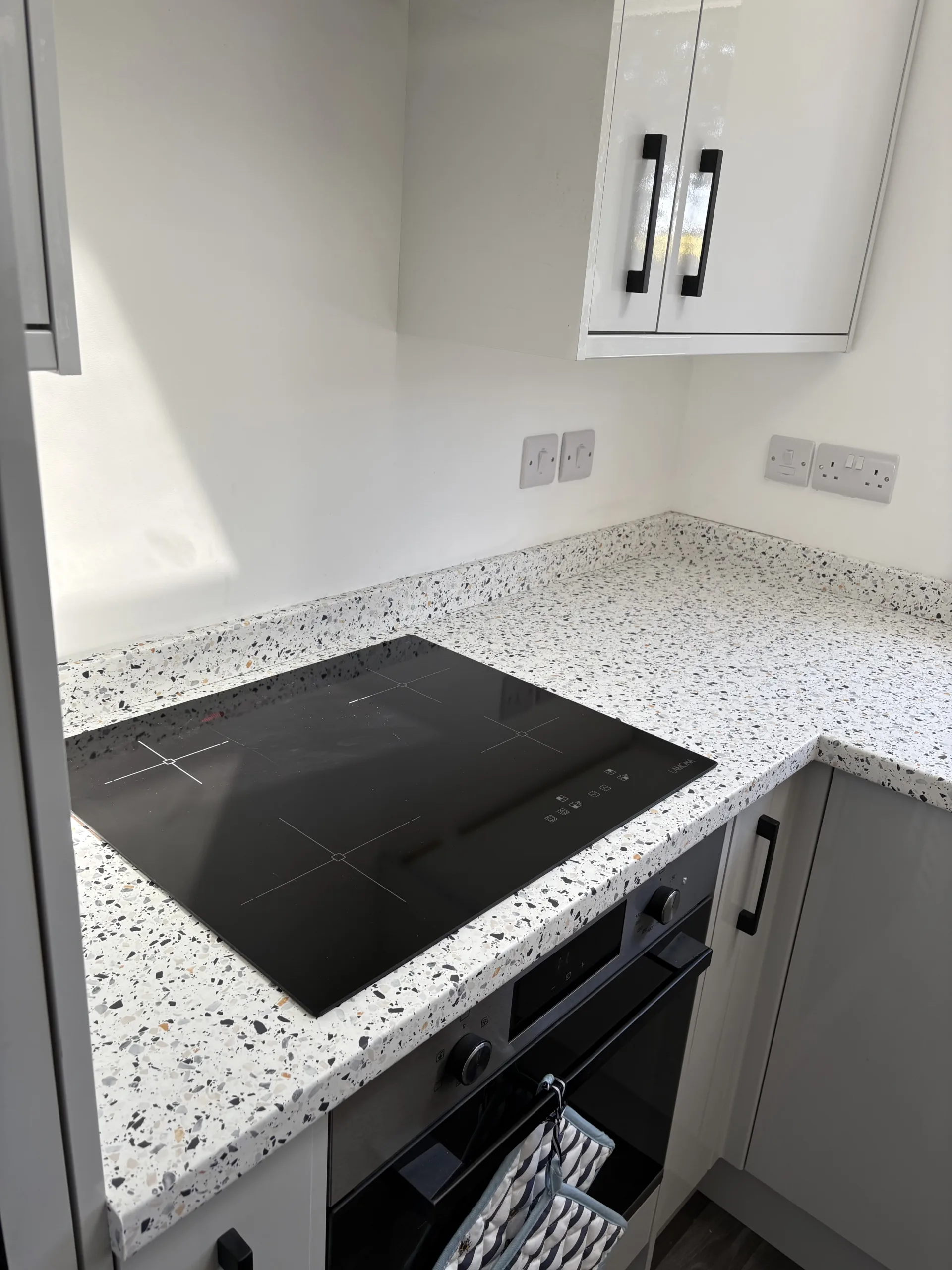 Close-up of finished light terrazzo-effect wrapped worktop and upstand in Bawburgh, near Norwich